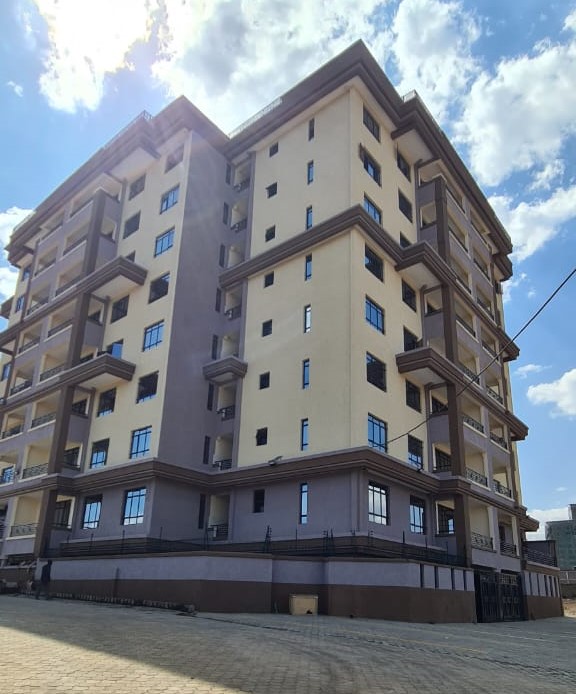 Located in Juja, Silver Pearl Residency comprises spacious 2 bedroom apartments (master ensuite) for rent provided with high end amenities. Key features include; a high speed lift, solar powered lighting, clean water throughout, electric fence with additional security measures, 24-hr CCTV surveillance, ample parking spaces, shop spaces, easy access to Thika Road, high quality finishes. Bedrooms are provided with spacious built-in wardrobes, wide windows for adequate natural lighting, washing area, rooftop hanging lines, children' s playground, etc. Get in touch for viewing and/or additional photos.